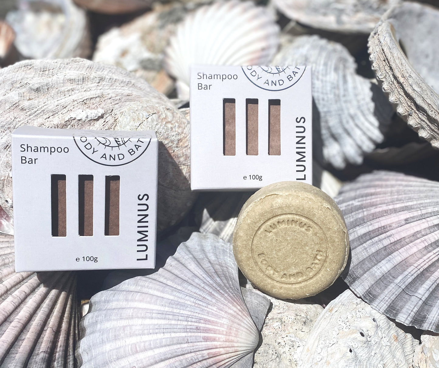 Luminus Quench Define shampoo bar for curl/wave hair definition with packaging on seashells