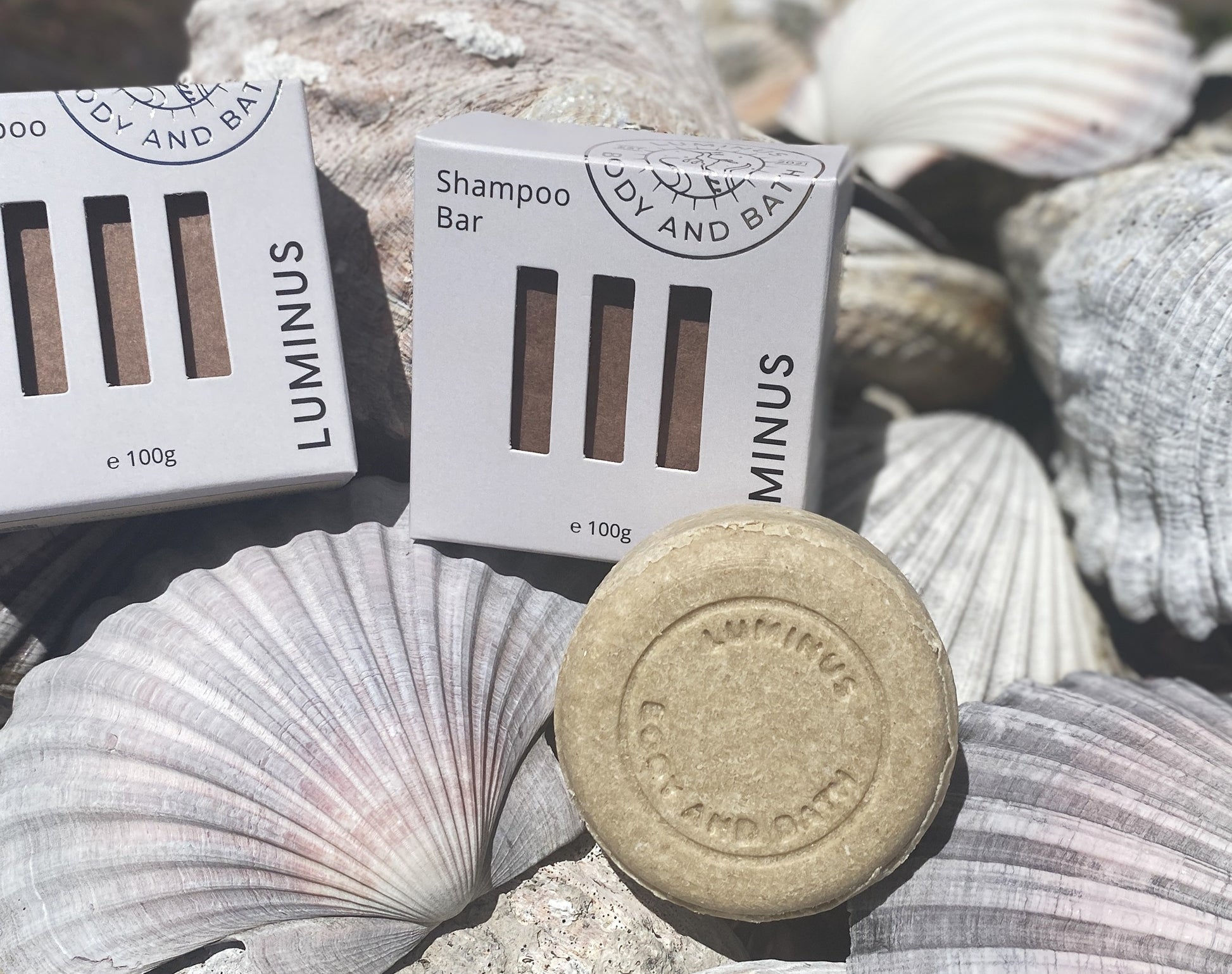Quench Define Shampoo bar with packaging on seashells